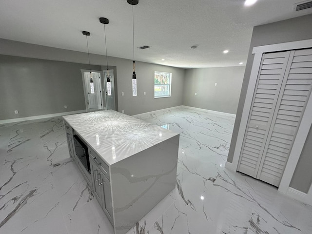 kitchen with light stone counters, light tile patterned floors, a center island, and pendant lighting