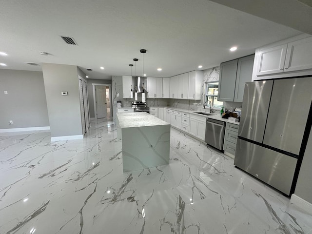 kitchen with stainless steel appliances, light stone counters, a center island, light tile patterned floors, and sink