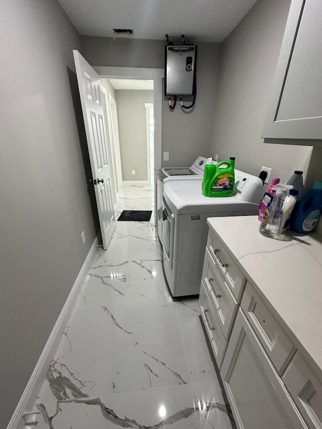 laundry area with a textured ceiling, cabinets, tankless water heater, light tile patterned floors, and separate washer and dryer