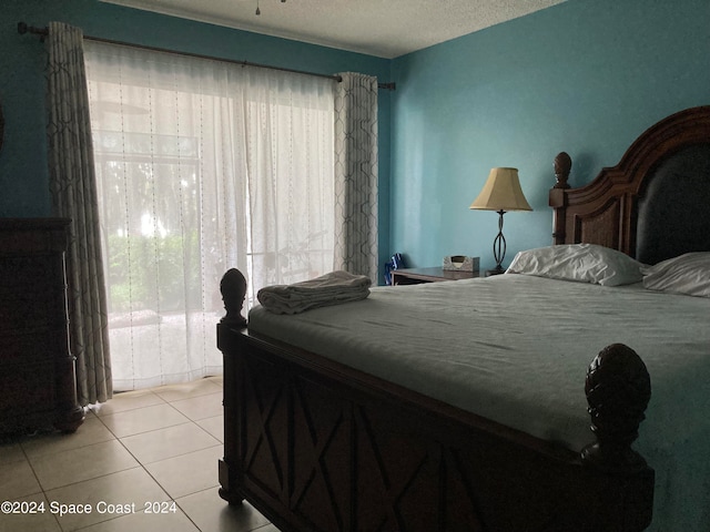 bedroom featuring a textured ceiling and light tile patterned flooring