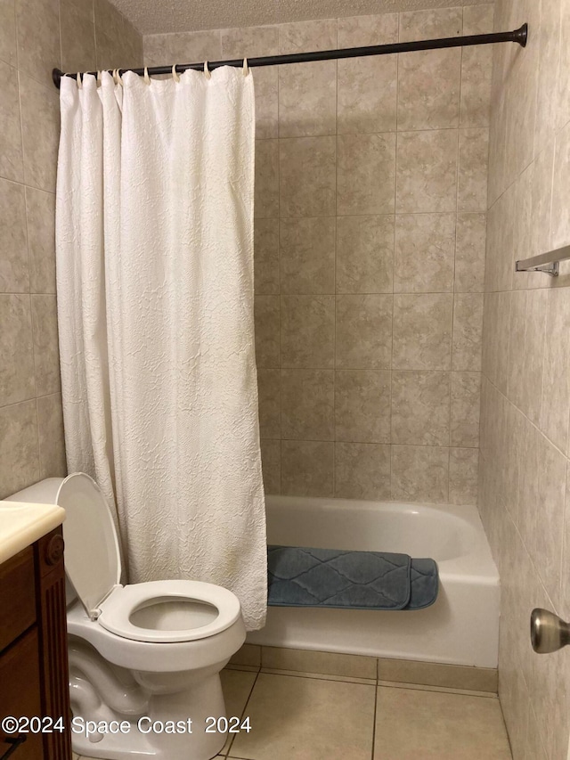 full bathroom with toilet, vanity, shower / bath combo with shower curtain, and tile patterned floors