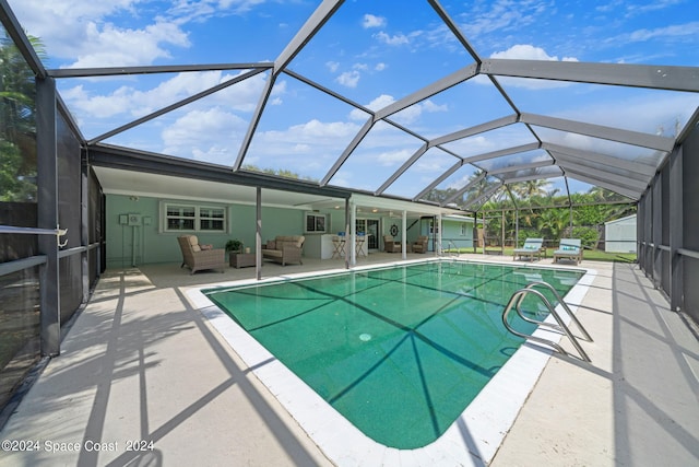 view of swimming pool with glass enclosure, outdoor lounge area, and a patio