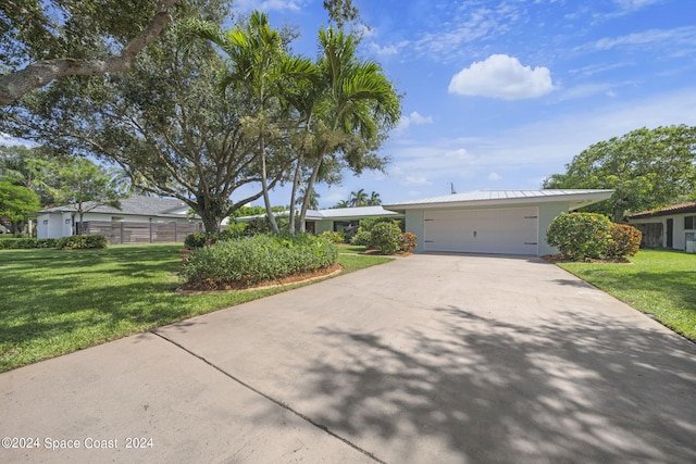 ranch-style home with a front lawn and a garage