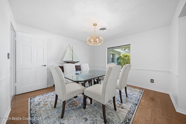 dining space featuring wood-type flooring