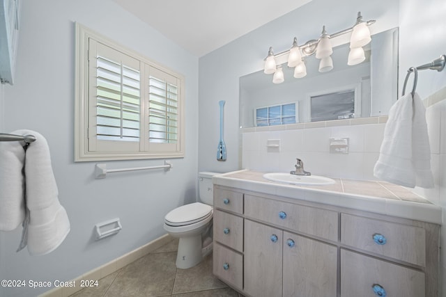 bathroom featuring backsplash, toilet, tile patterned flooring, and vanity