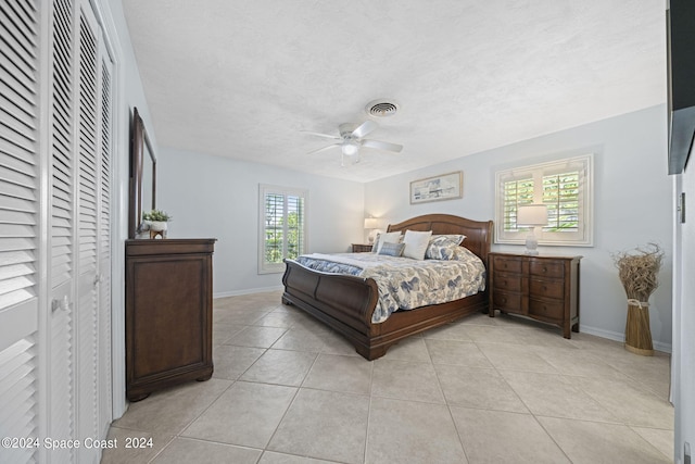 bedroom with ceiling fan and light tile patterned floors