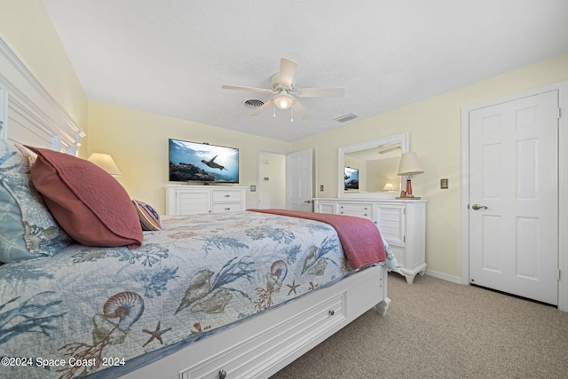 bedroom featuring ceiling fan and light carpet