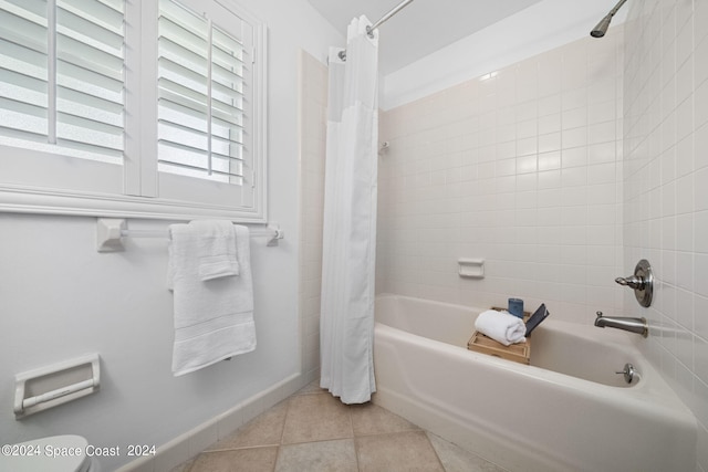 bathroom featuring shower / bath combination with curtain, toilet, and tile patterned floors