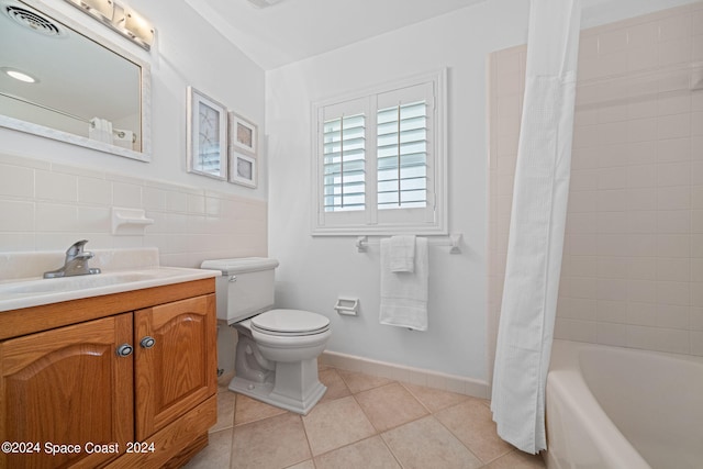 full bathroom featuring decorative backsplash, tile walls, tile patterned flooring, vanity, and toilet