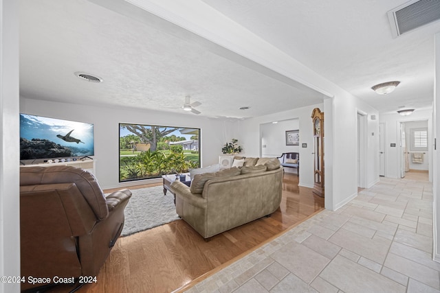 living room with ceiling fan and light hardwood / wood-style floors