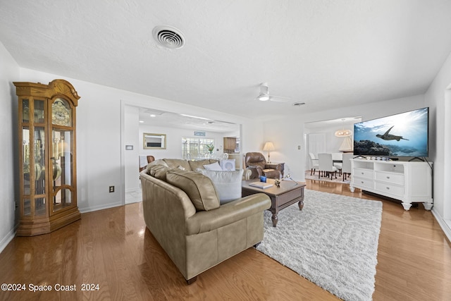 living room featuring ceiling fan and light wood-type flooring