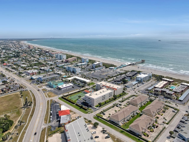 drone / aerial view featuring a beach view and a water view