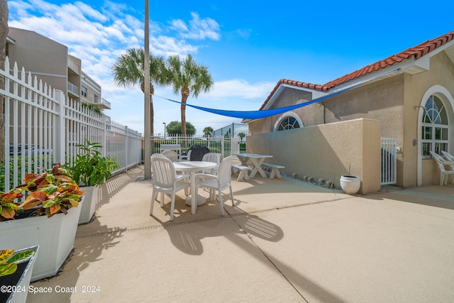 view of patio / terrace with outdoor dining area and fence