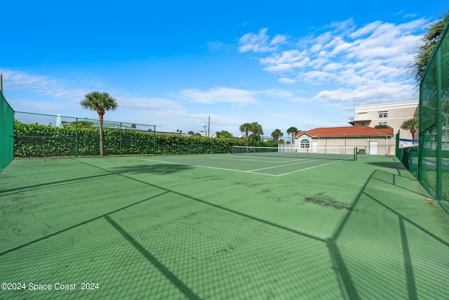 view of tennis court with fence