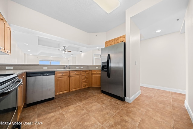 kitchen with light tile patterned floors, stainless steel appliances, sink, light brown cabinets, and ceiling fan