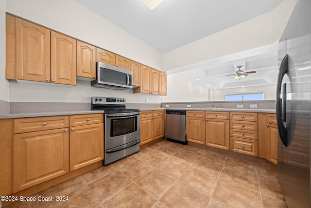 kitchen with stainless steel appliances, sink, light tile patterned floors, and ceiling fan