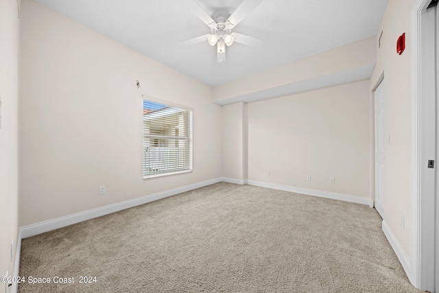 empty room featuring carpet, ceiling fan, and baseboards