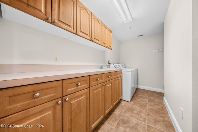 washroom featuring separate washer and dryer, light tile patterned floors, cabinets, and sink