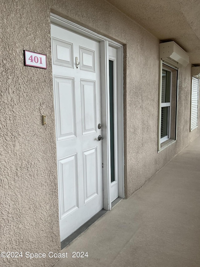 property entrance with stucco siding