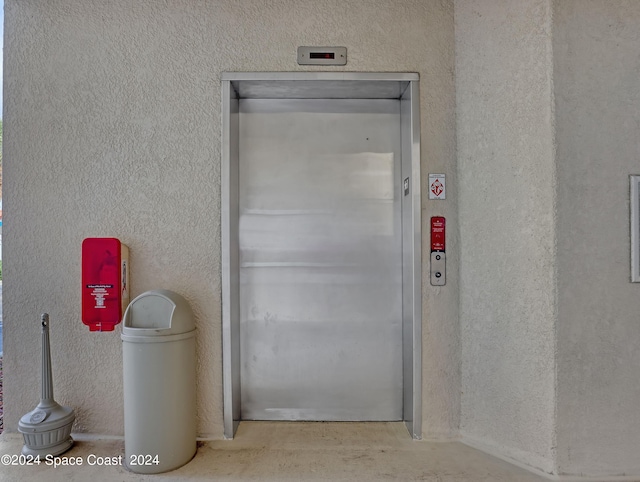 interior space featuring elevator and concrete flooring