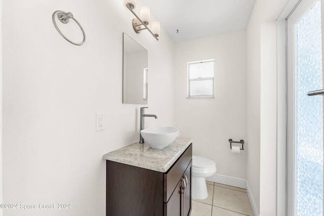 bathroom featuring vanity, tile patterned flooring, and toilet