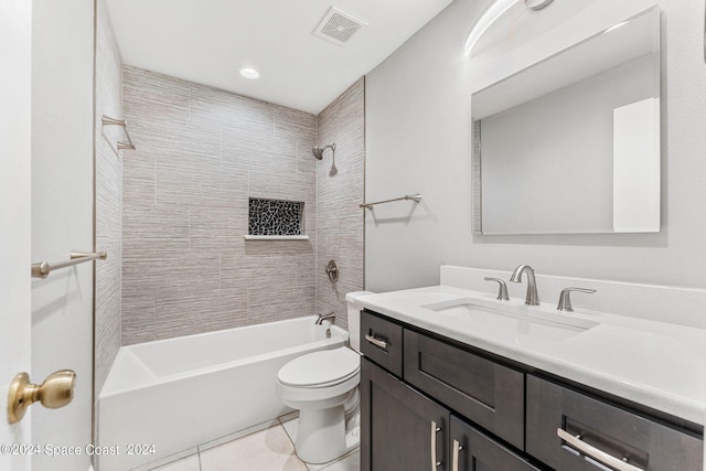 full bathroom featuring tiled shower / bath, vanity, toilet, and tile patterned floors