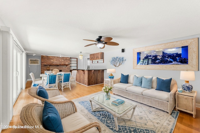 living room with ceiling fan and light hardwood / wood-style flooring