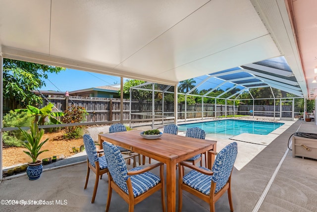 view of swimming pool with a lanai and a patio area