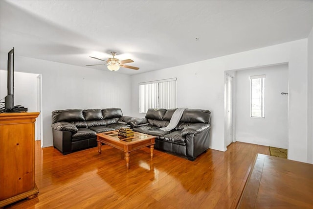 living room featuring ceiling fan and light hardwood / wood-style floors