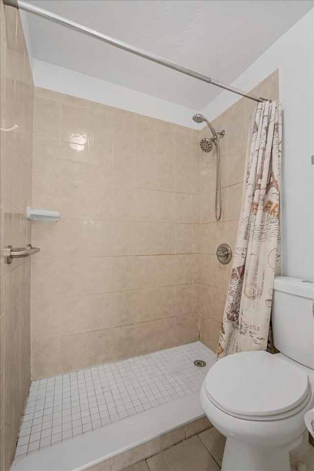 7817 Maplewood Dr Unit 601, Melbourne, FL 32904 - full bathroom with a stall shower, tile patterned flooring, and toilet