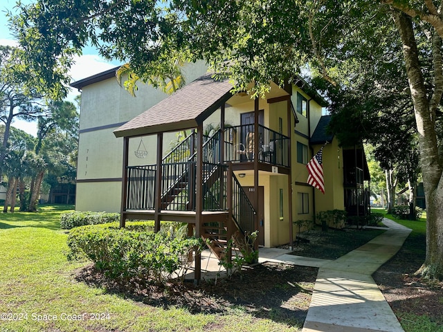 view of front of house featuring a deck and a front yard