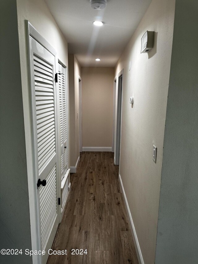 hall with dark hardwood / wood-style floors