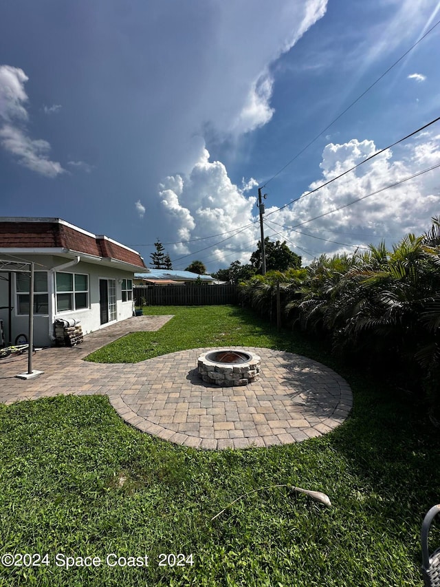 view of yard with a patio and a fire pit