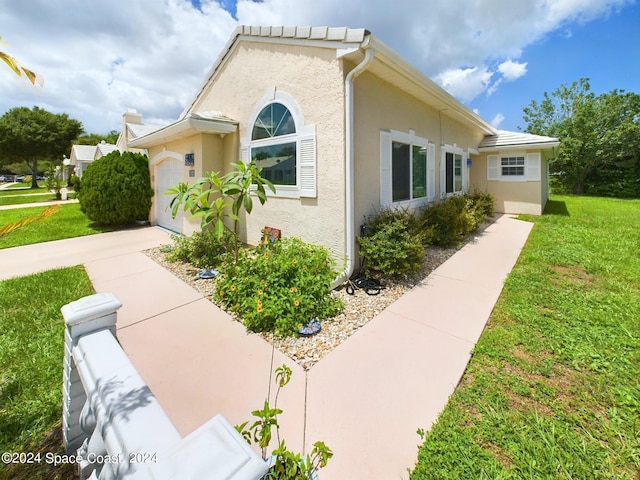 view of property exterior with a yard