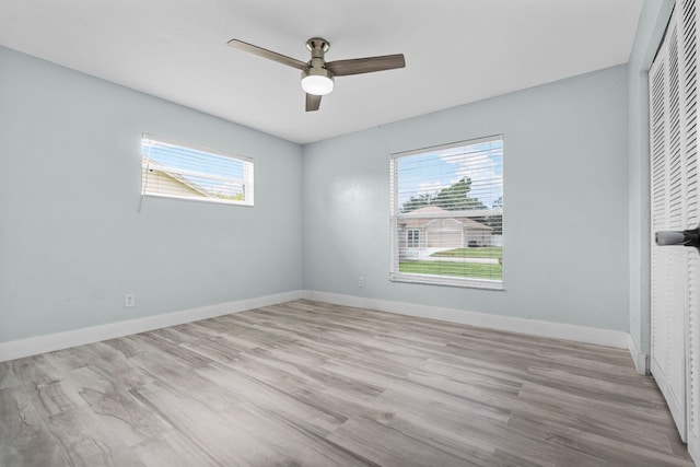 unfurnished room featuring ceiling fan and light wood-type flooring