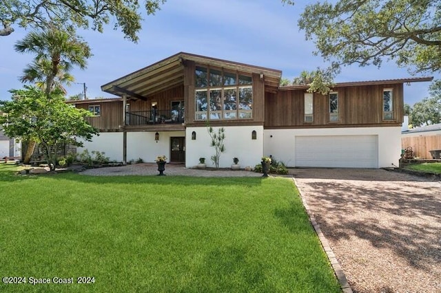 view of front of house with a front yard and a garage