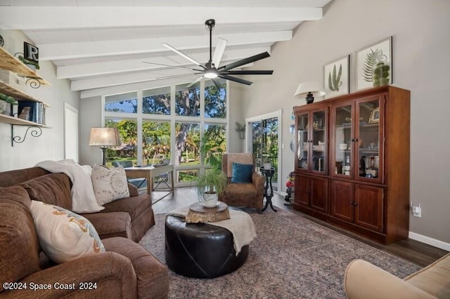 living room featuring hardwood / wood-style floors, vaulted ceiling with beams, and ceiling fan