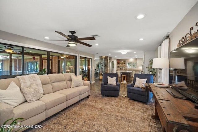 living room featuring hardwood / wood-style flooring and ceiling fan