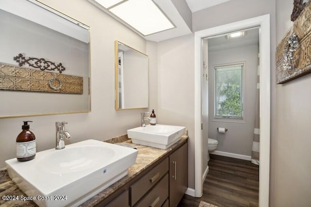 bathroom featuring vanity, toilet, and wood-type flooring