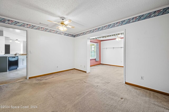 tiled spare room with a textured ceiling and ceiling fan