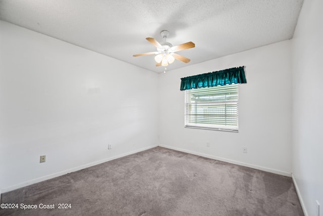 carpeted empty room with ceiling fan and a textured ceiling