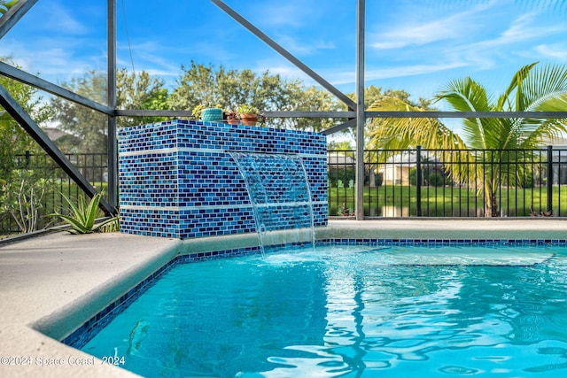 view of pool featuring pool water feature and glass enclosure