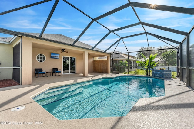 view of pool featuring a lanai, ceiling fan, and a patio area