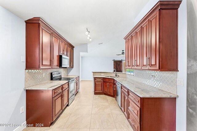 kitchen with light stone counters, appliances with stainless steel finishes, sink, and backsplash