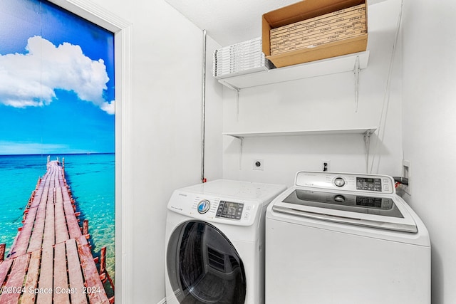 laundry room with a water view and separate washer and dryer