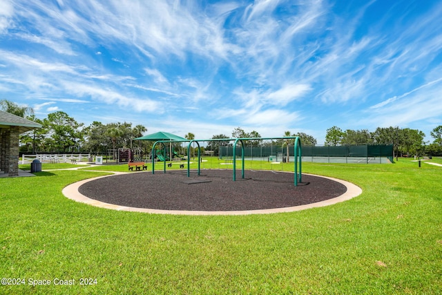 view of jungle gym featuring a lawn