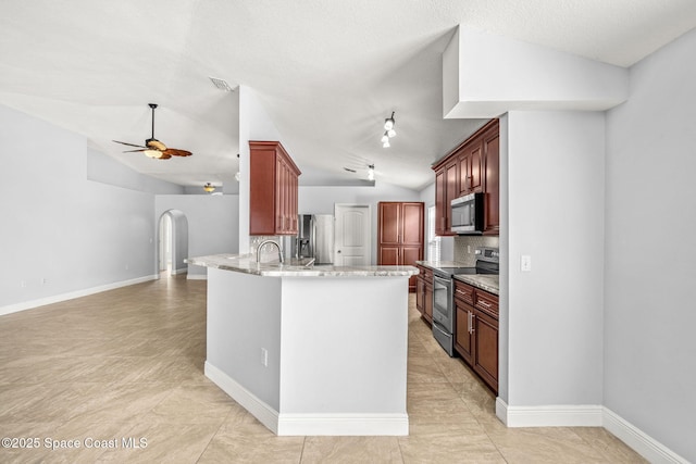 kitchen with vaulted ceiling, backsplash, ceiling fan, kitchen peninsula, and stainless steel appliances