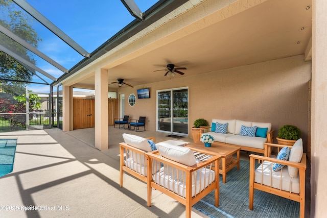 view of patio featuring ceiling fan, outdoor lounge area, and glass enclosure