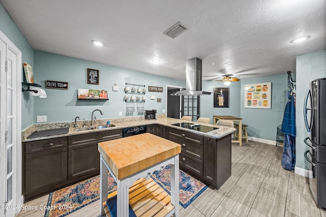 kitchen with ceiling fan, island exhaust hood, sink, kitchen peninsula, and black appliances