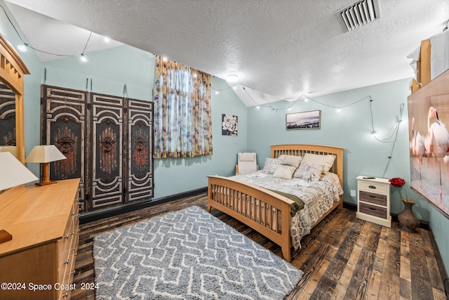 bedroom featuring wood-type flooring and a textured ceiling